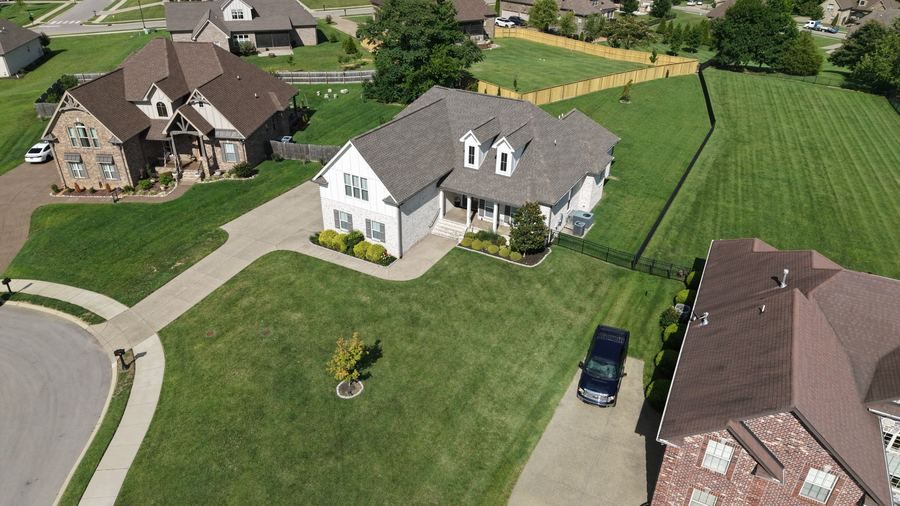Aerial view of white farmhouse exterior